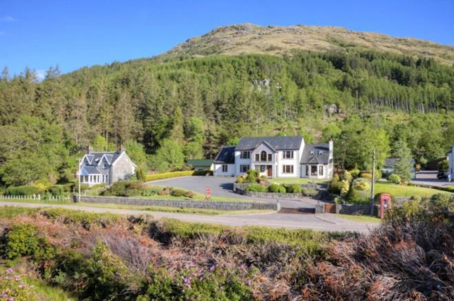 a large house in the middle of a mountain at Ardno House B & B in Glencoe