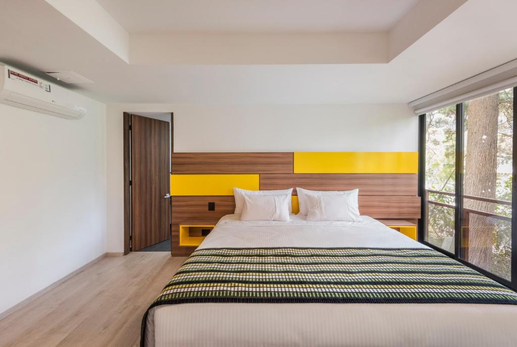 Postel nebo postele na pokoji v ubytování Foresta Hotel