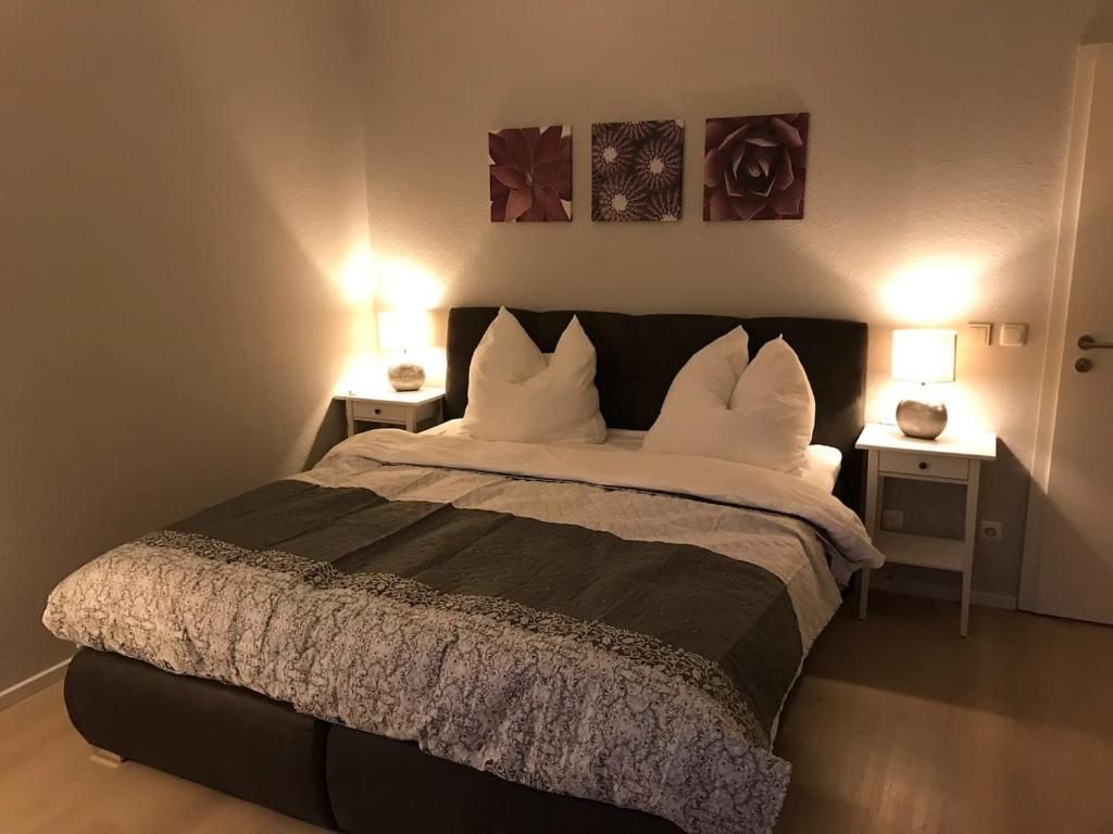 a bedroom with a large bed with two night stands at Ferienwohnung Lauer in Ellerstadt