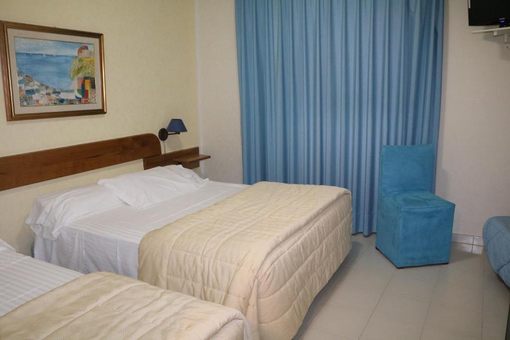 Postel nebo postele na pokoji v ubytování Hotel Marinella