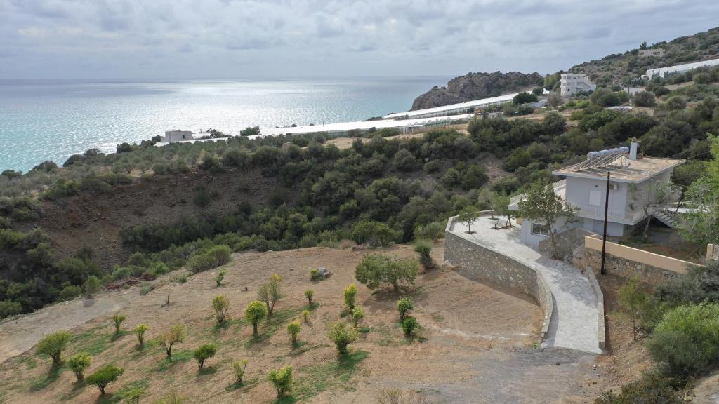 an aerial view of a hill next to the ocean at Skouros Villa in Kastrí