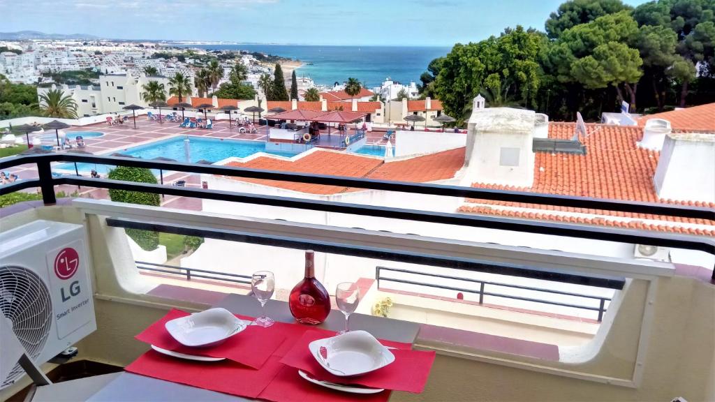 a balcony with a table with a view of a pool at Sea View5 in Albufeira