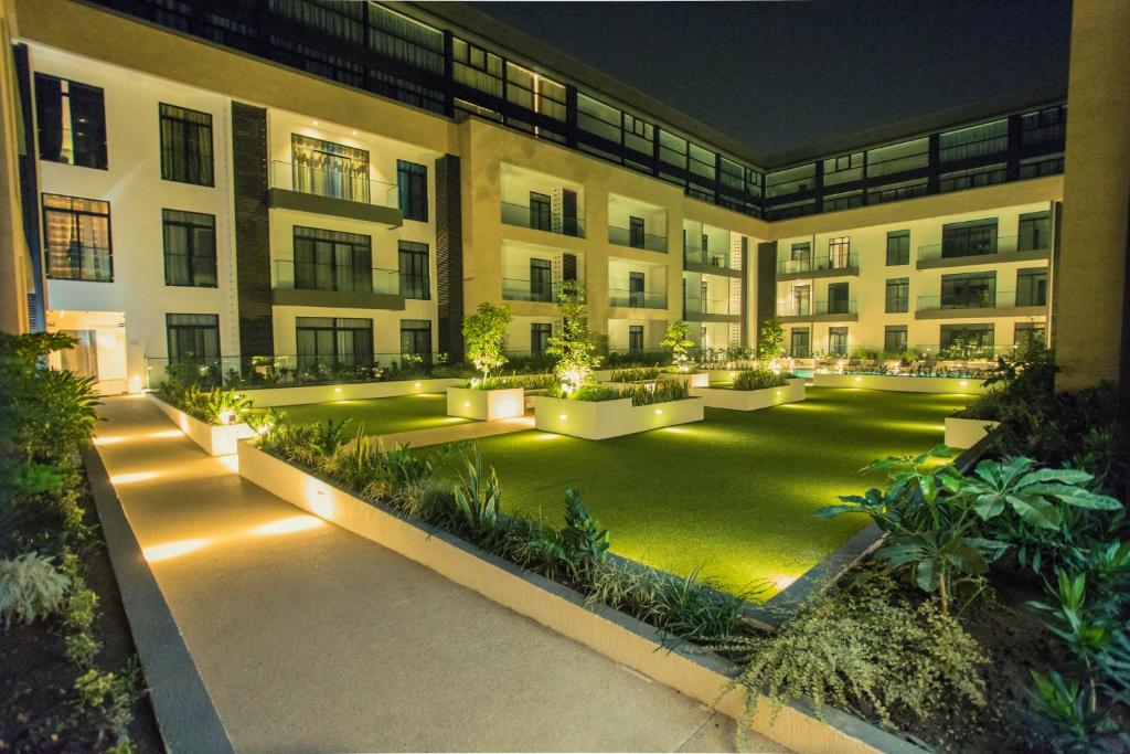 an apartment building with a courtyard at night at Accra Luxury Apartments @ The Gardens in Accra