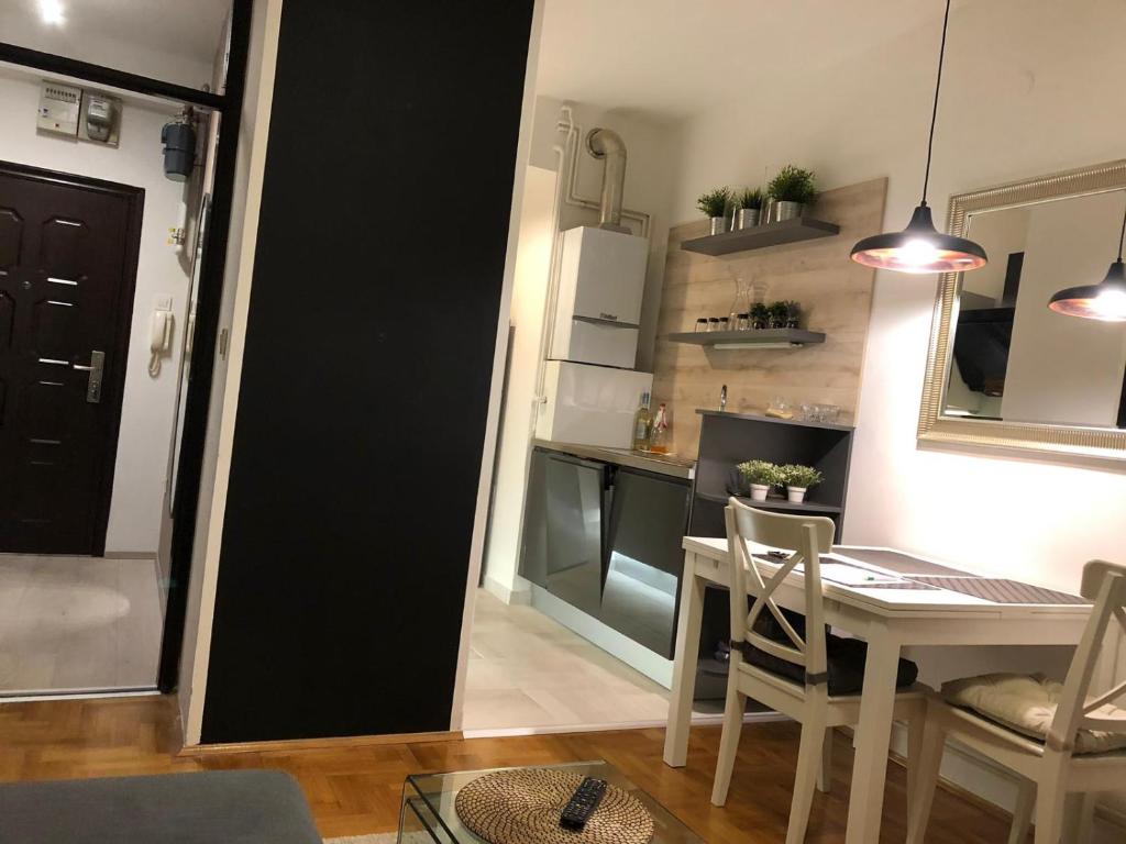 a kitchen and dining room with a table and chairs at Irena's Home away from home in Zagreb