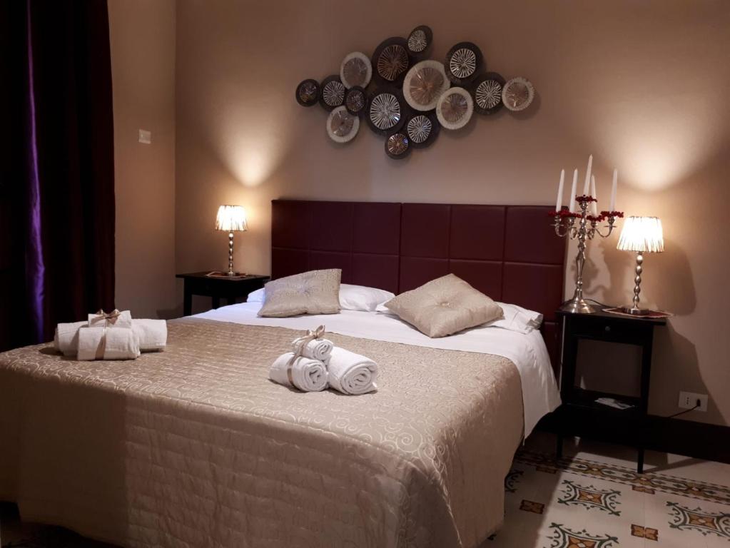 a bedroom with a large bed with towels on it at AL-ZABUT in Sambuca di Sicilia