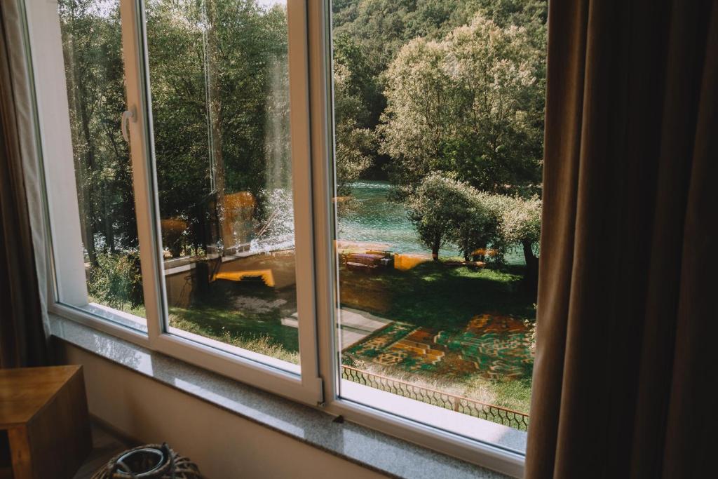 a window with a view of a garden at Apartment Anur in Bihać