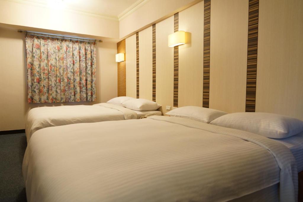 Postel nebo postele na pokoji v ubytování Ying Dai Hotel