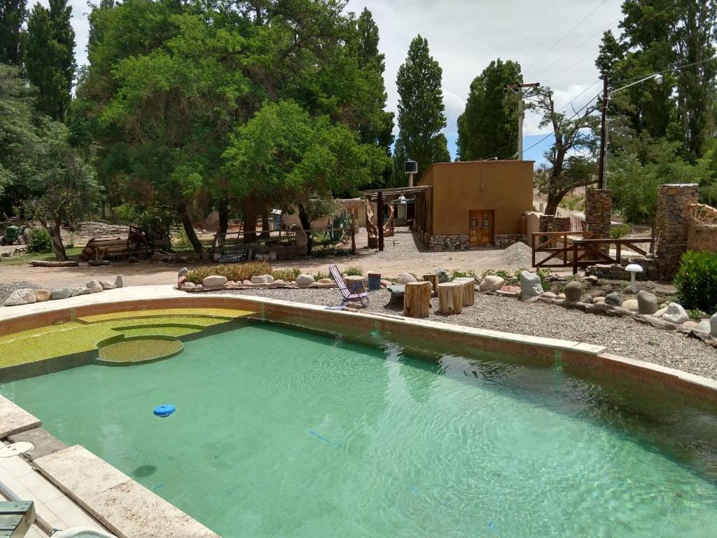 - une grande piscine dans une cour avec une maison dans l'établissement La Comarca del Jarillal, à Las Flores