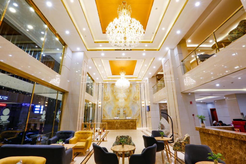 a lobby with a chandelier and tables and chairs at Diamond Pearl Hotel ,Phnom Penh,Royel Palace, Mekong RIver,Swimming Pool in Phnom Penh