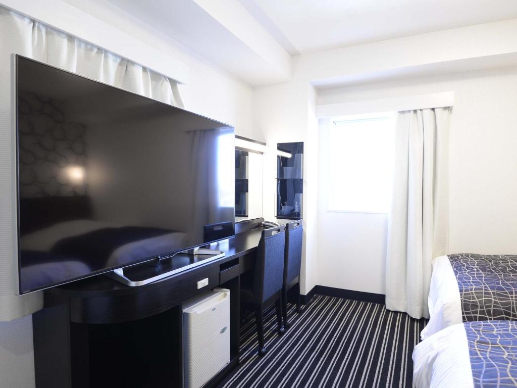Postel nebo postele na pokoji v ubytování APA Hotel Mito-eki Kita
