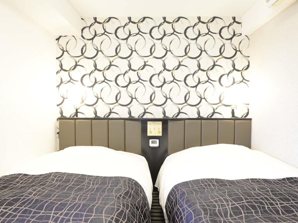 Postel nebo postele na pokoji v ubytování APA Hotel Mito-eki Kita