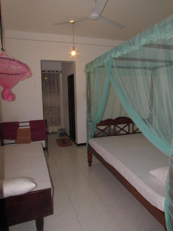 Postel nebo postele na pokoji v ubytování Rainbow Guest House
