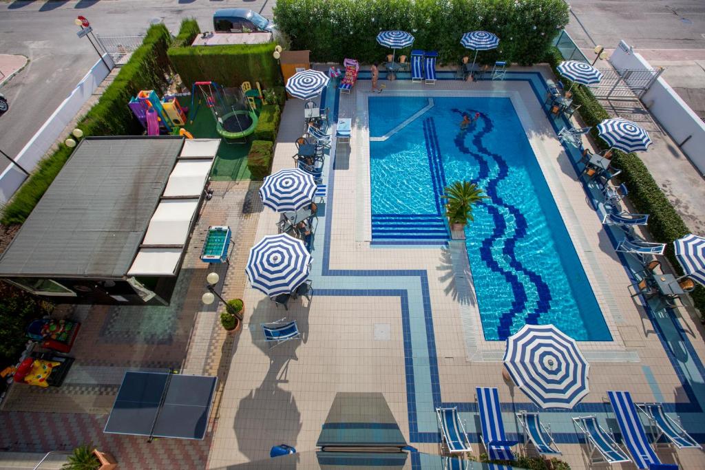 an overhead view of a swimming pool with umbrellas at Hotel Ambassador in Tortoreto Lido