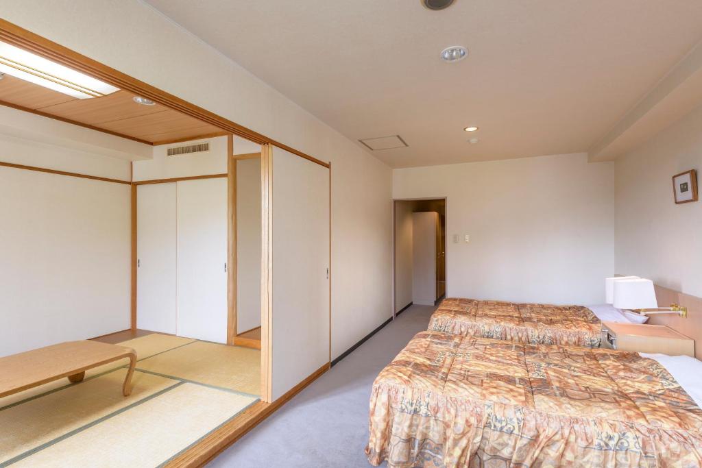 Postel nebo postele na pokoji v ubytování Hotel Tagawa