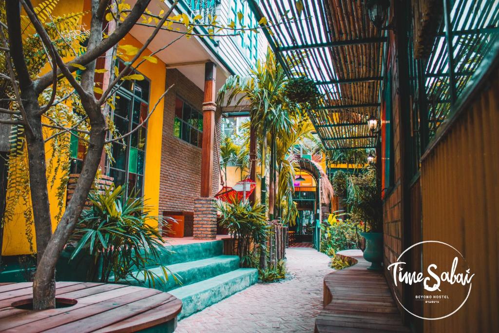 a courtyard with stairs and plants in a building at Time Sabai 134 in Bangkok