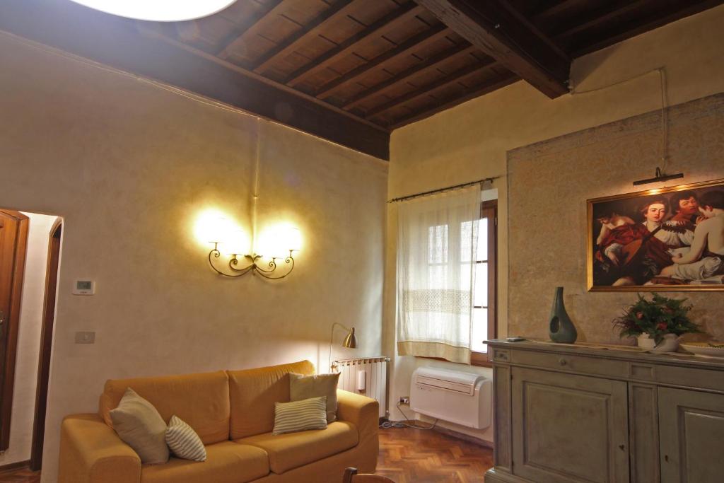 a living room with a couch and a painting on the wall at Verrazzano Apartment in Florence