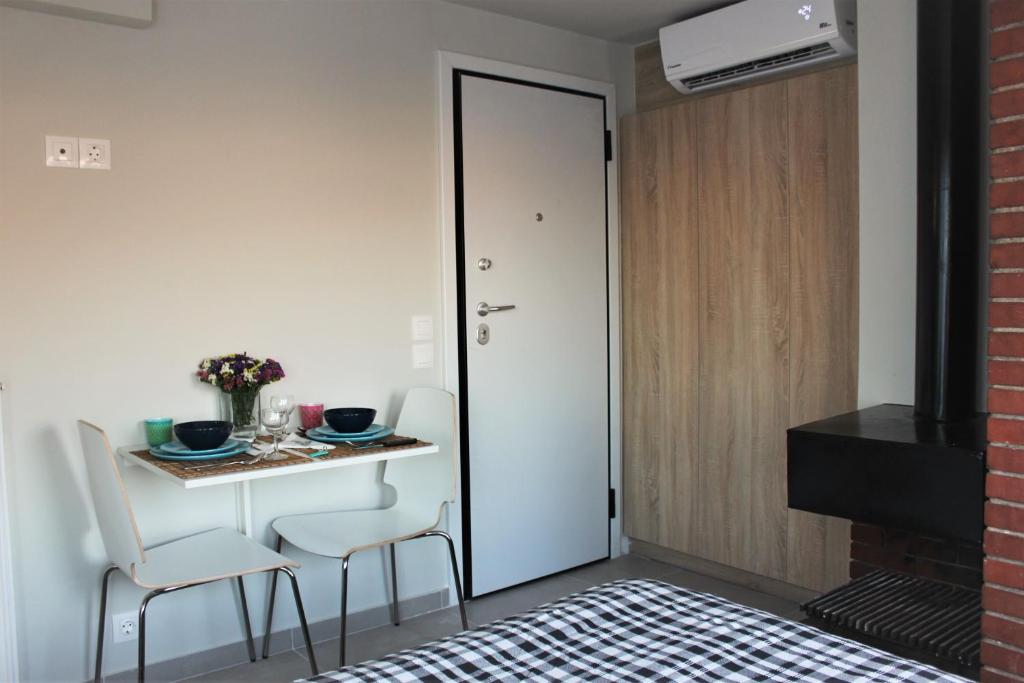 a room with a table and chairs and a door at Xenon Loft in Athens