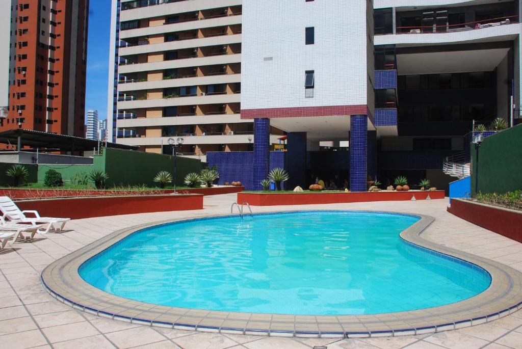a large swimming pool on top of a building at Porto de Iracema - Iracema Imoveis in Fortaleza