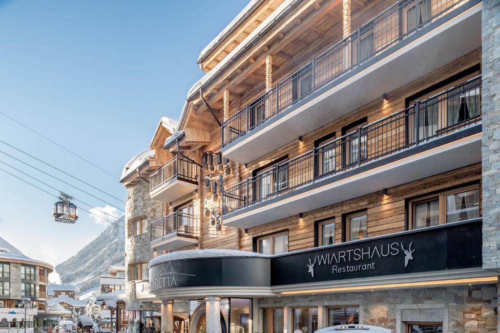 a building with a sign on the side of it at Sport- und Genusshotel Silvretta in Ischgl