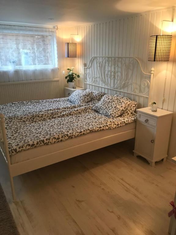 1 dormitorio con 1 cama grande y suelo de madera en Room with pentry, separate entrance, no cardpayment en Gränna