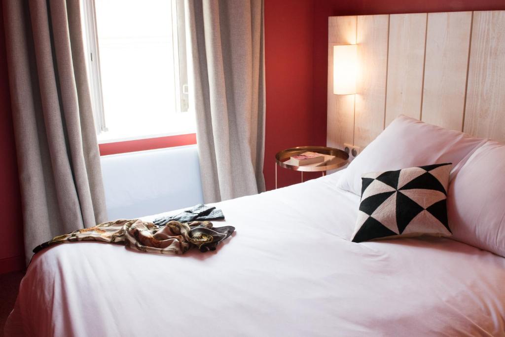 Postel nebo postele na pokoji v ubytování Le Central Boutique Hôtel