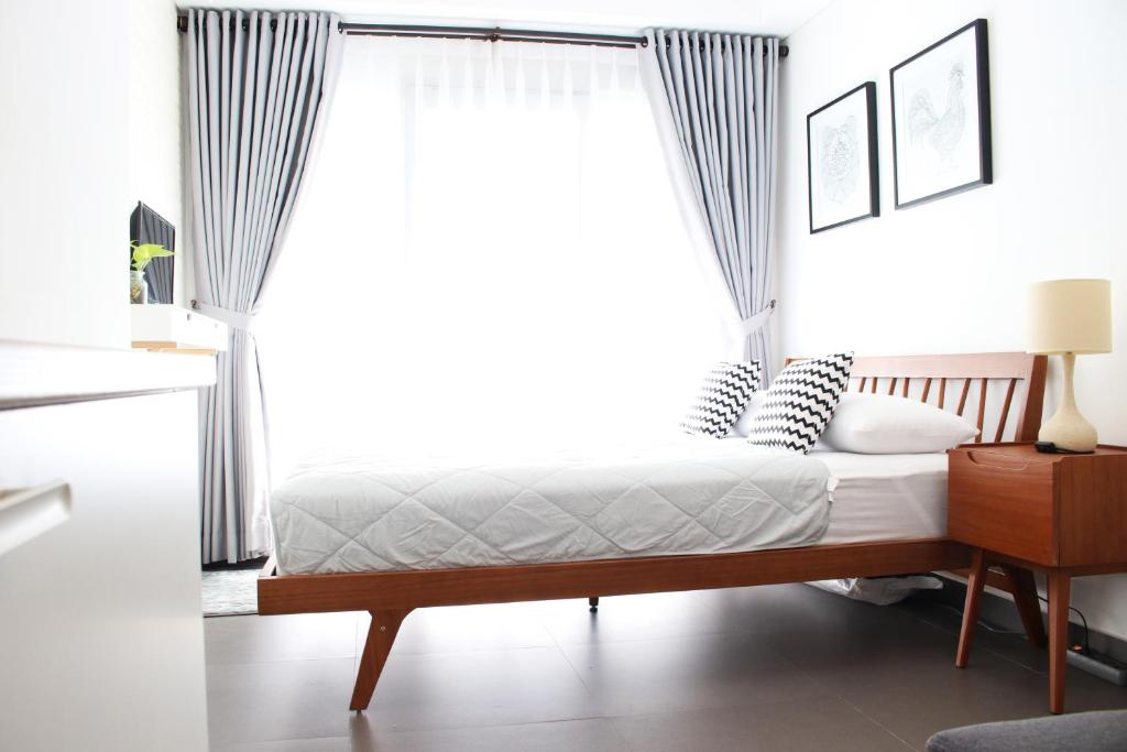 a bedroom with a bed and a window at Scandinavian Asia Afrika in Bandung