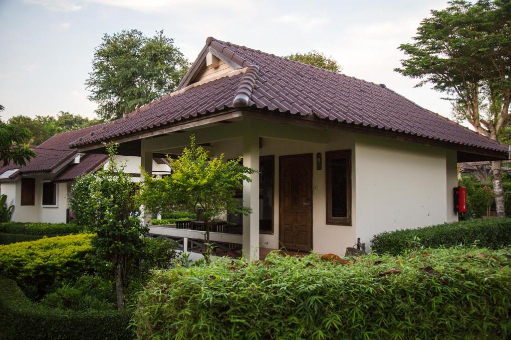 a small white house with a brown roof at Ao Cho Grandview Hideaway Resort in Ko Samed