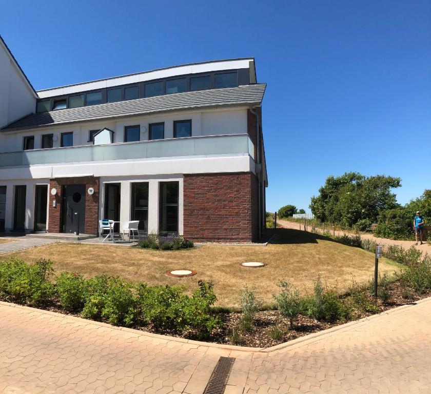 a large building with a lawn in front of it at Nummer Zwo in Helgoland