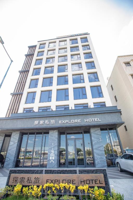 a hotel building with a sign in front of it at Explore Hotel in Taichung