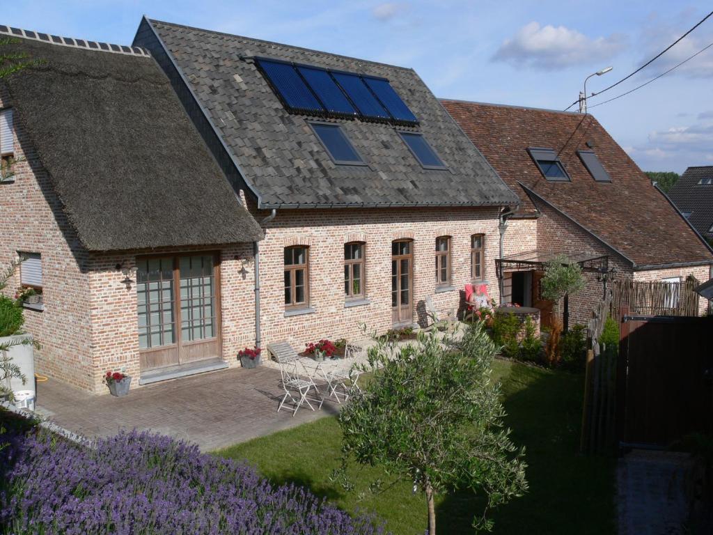 Casa della Nonna في Zwalm: منزل به سقف مع لوحات شمسية