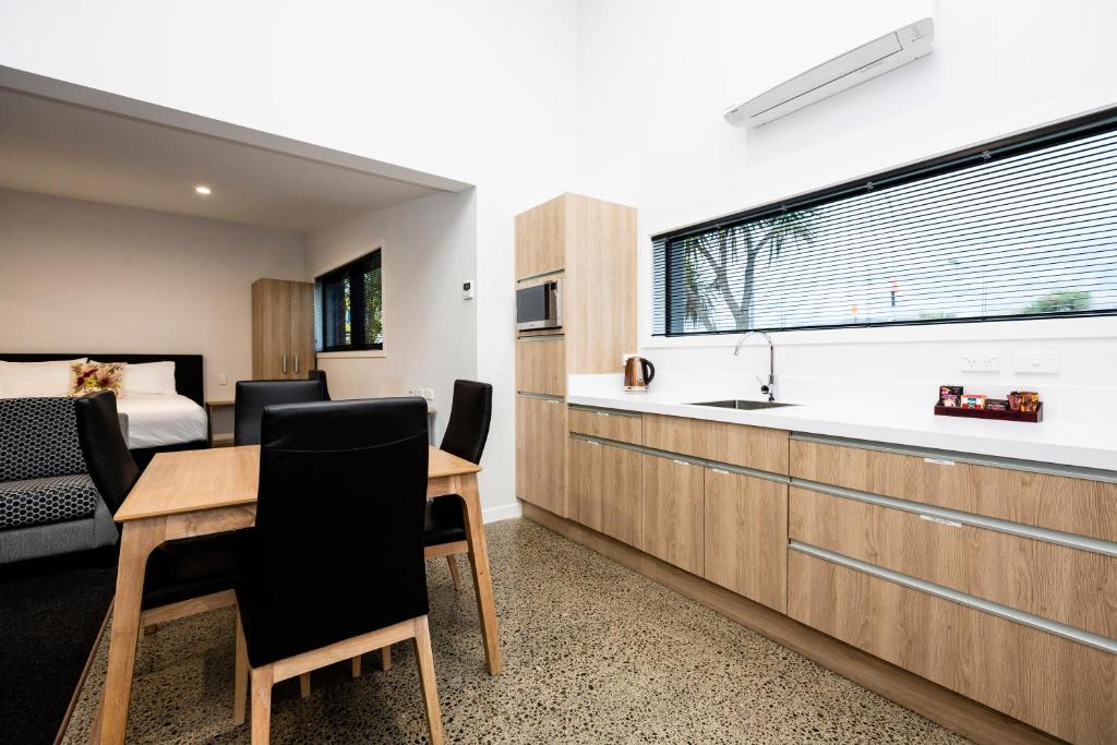 a kitchen with a table and chairs and a bedroom at Zachary's Motel in Levin