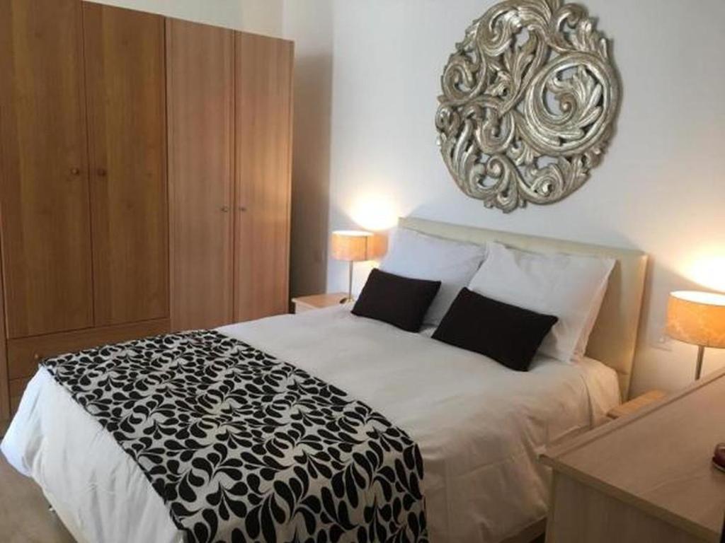 a bedroom with a bed with a black and white blanket at Ocean View, Apartment 1 in Marsaskala