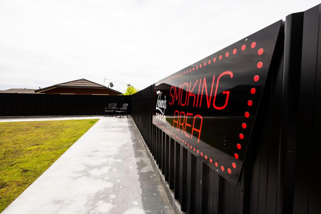 a black fence with a sign on the side of it at Zachary's Motel in Levin