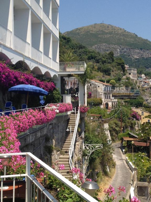 a view of a building with flowers on a hill at Hotel Voce del Mare in Vietri sul Mare