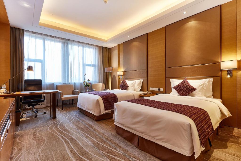 Postel nebo postele na pokoji v ubytování Wyndham Jingzhou