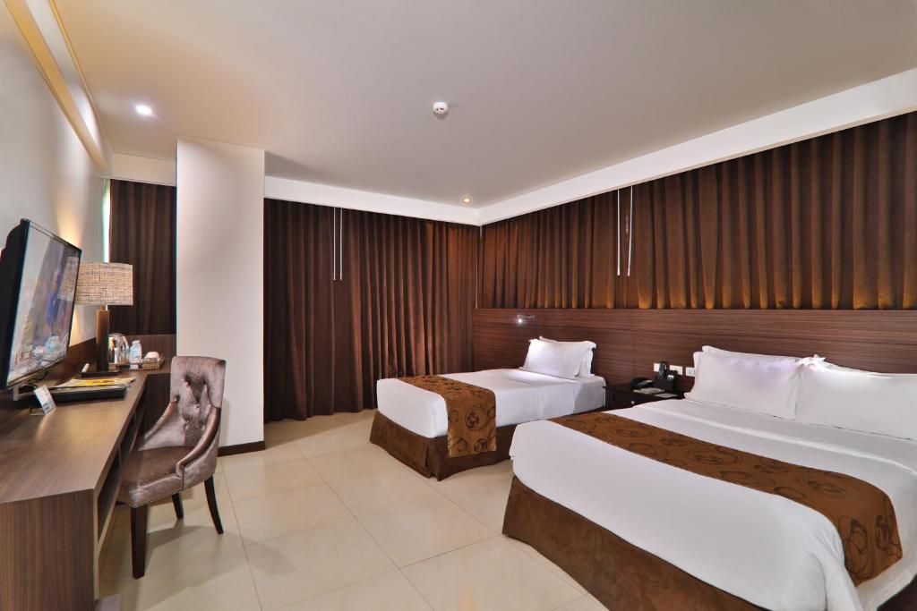 Postel nebo postele na pokoji v ubytování Kew Hotel Tagbilaran
