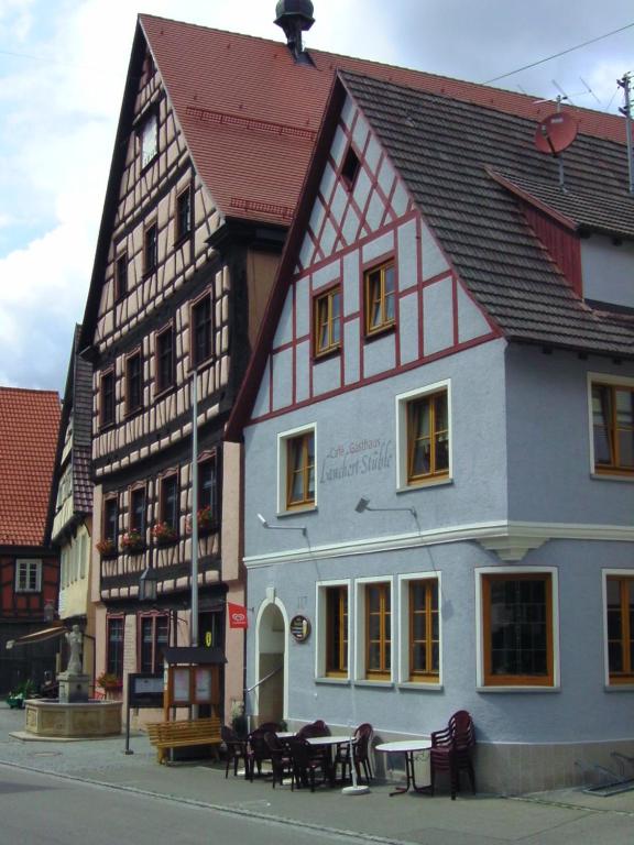 a building with tables and chairs in front of it at Lauchertstüble in Veringenstadt