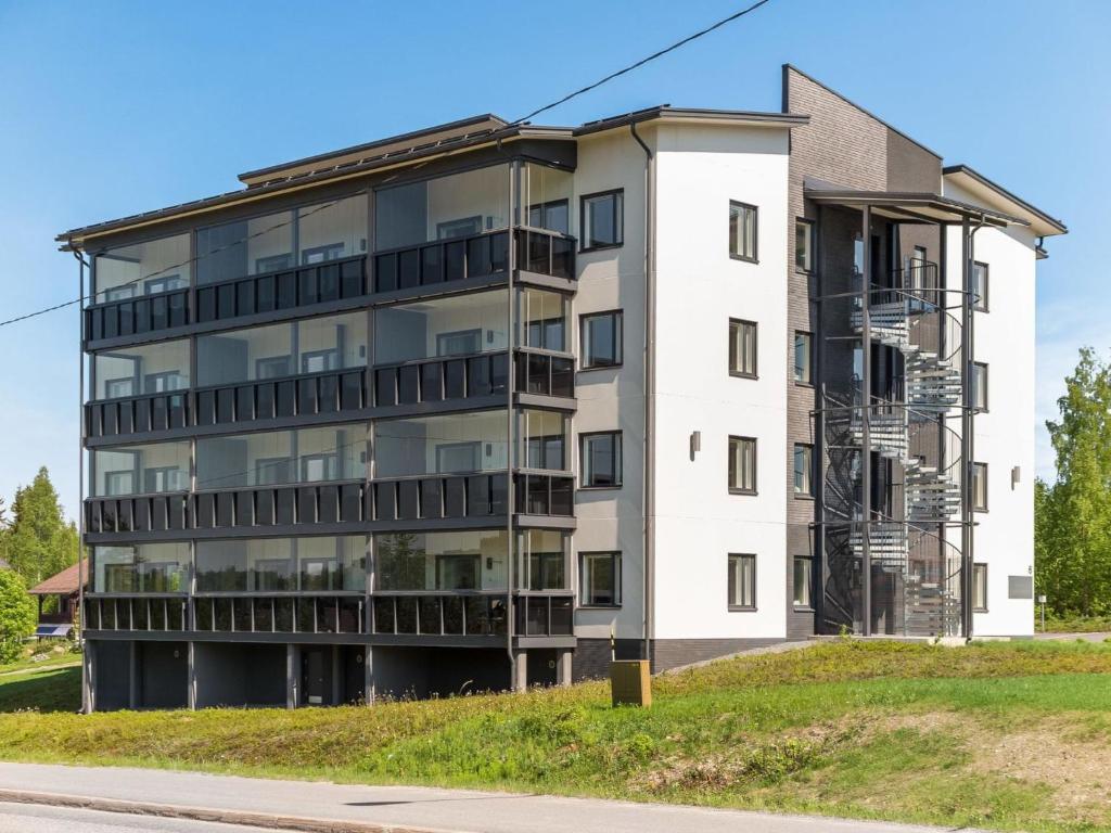 an apartment building on the side of a street at Holiday Home Tahko spa red - golf apartment by Interhome in Tahkovuori