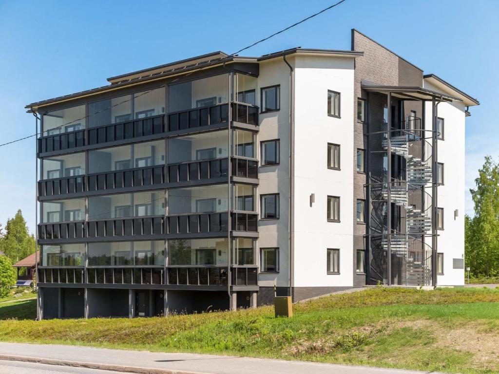 an apartment building on the side of a street at Holiday Home Tahko spa red - vuori apartment by Interhome in Tahkovuori