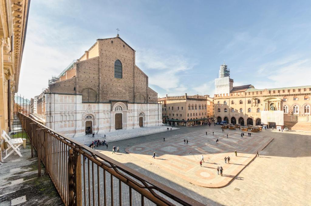 a view of a church with a courtyard in front of it at Piazza Maggiore Suite in Bologna
