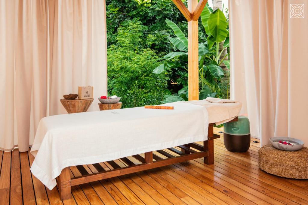 a bed in a room with a large window at Zuri Zanzibar in Kendwa