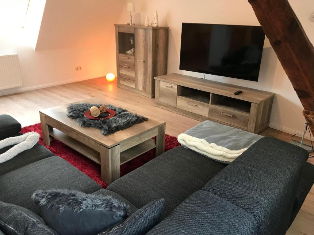 a living room with a couch and a flat screen tv at Haus-Hafenblick in Lassan