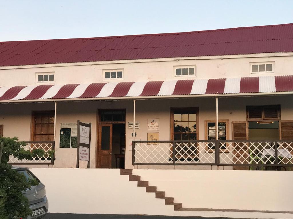 a white building with a red and white awning at EpiStay in Tulbagh