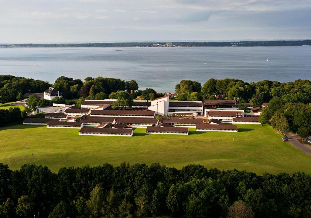 an aerial view of a building with the water in the background at Konventum Conference Center in Helsingør