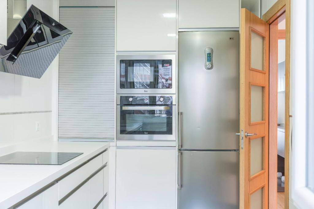 Kuchyň nebo kuchyňský kout v ubytování Apartamento Ria de Boo, Con patio privado