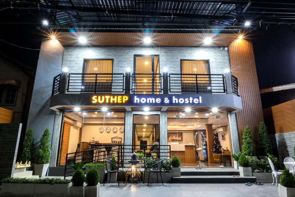a store front of a home and hospital at night at Suthep Home & Hostel in Bangkok