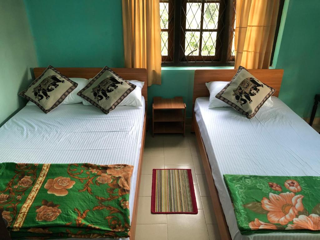 Un pat sau paturi într-o cameră la Araliya Holiday Bungalow