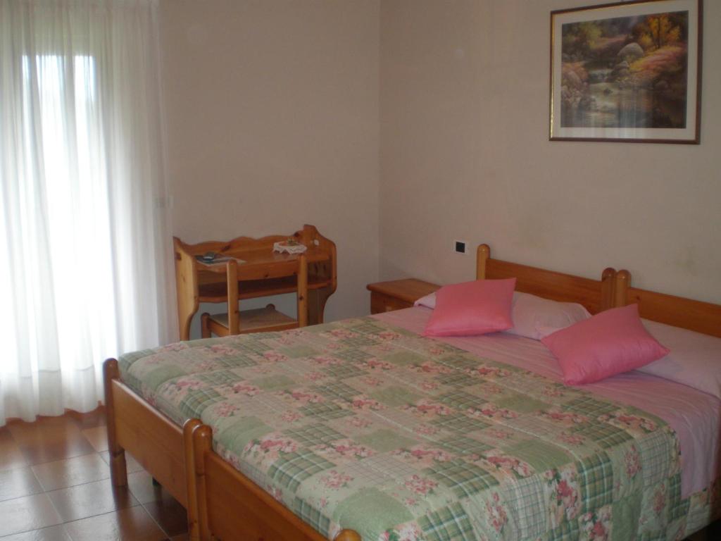 Postel nebo postele na pokoji v ubytování Hotel Residence La Rosa