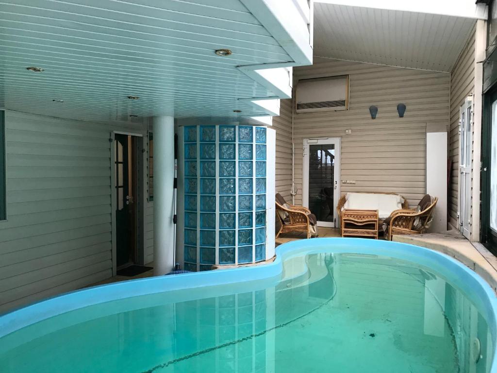 a swimming pool in the backyard of a house at Guest House Krista in Jūrmala