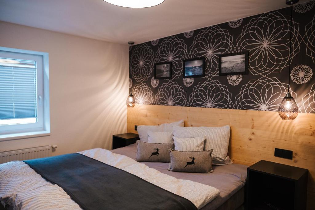 a bedroom with a bed with two pillows on it at Apart Julia in Längenfeld